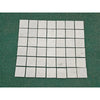 Carrara white marble 4x4 tumbled tiles with white marble mosaic and subtle gray veining arranged in a grid pattern
