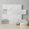 Carrara white marble 6x12 polished or honed white rectangular tiles with subtle gray veining in a staggered pattern