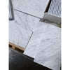 Carrara white marble 6x12 polished tiles with gray veining, stacked in plastic
