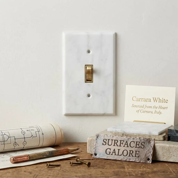 Carrara white marble single toggle plate switch wall plate featuring a brass toggle on white carrara marble
