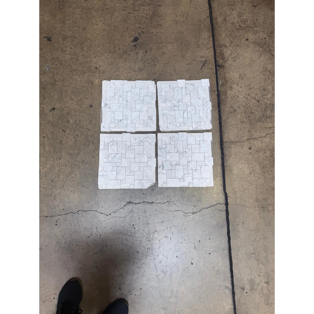 Four white mosaic tile squares of Carrara White Mini-Versailles Pattern Marble Tile