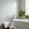 White marble-veined subway tile wall with herringbone pattern in polished carrara white mini versailles mosaic marble tile