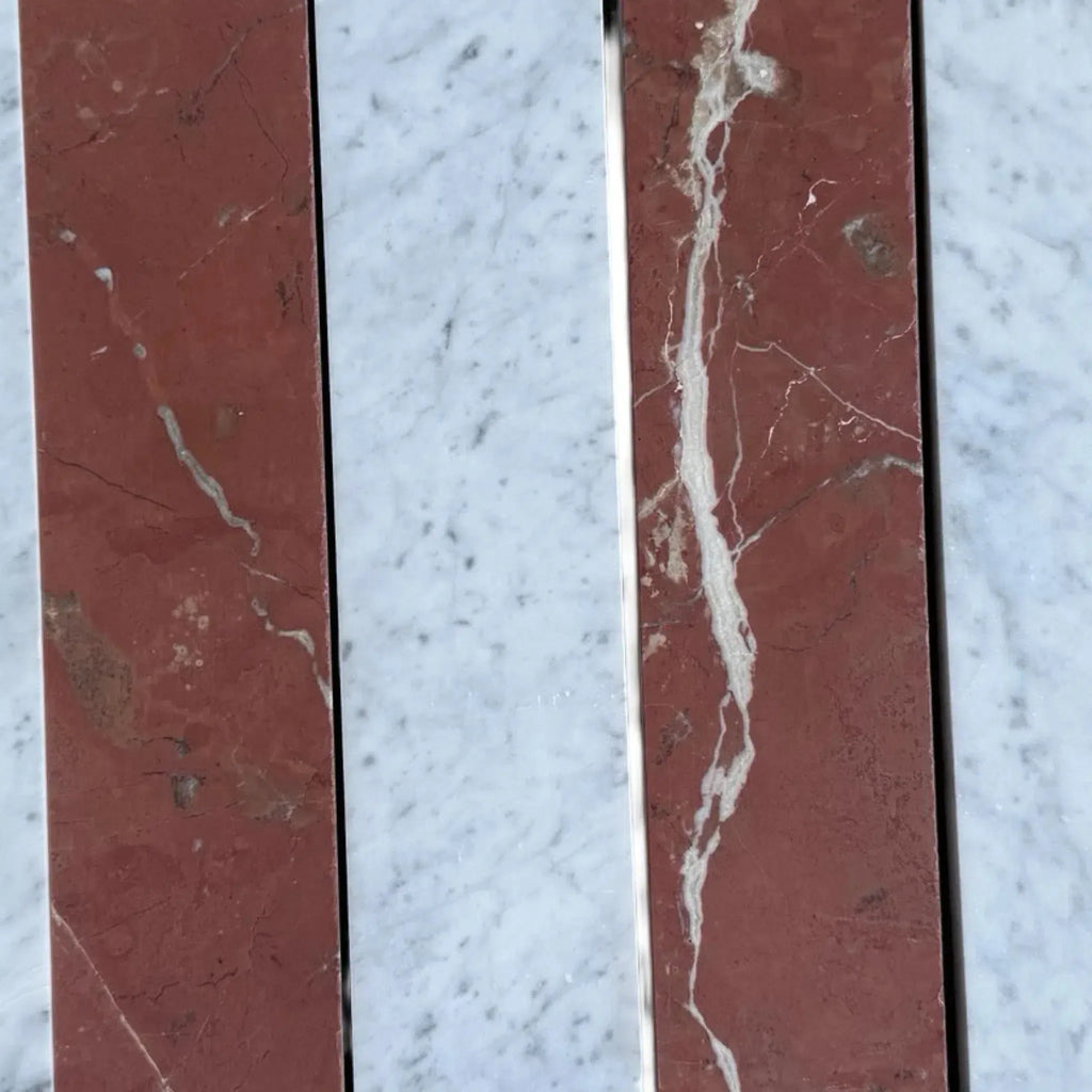 Red marble slabs with white veining in Carrara White Rojo Alicante field tile