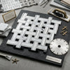 Carrara white triple-weave mosaic marble tile polished with black arranged in woven pattern on dark slate board