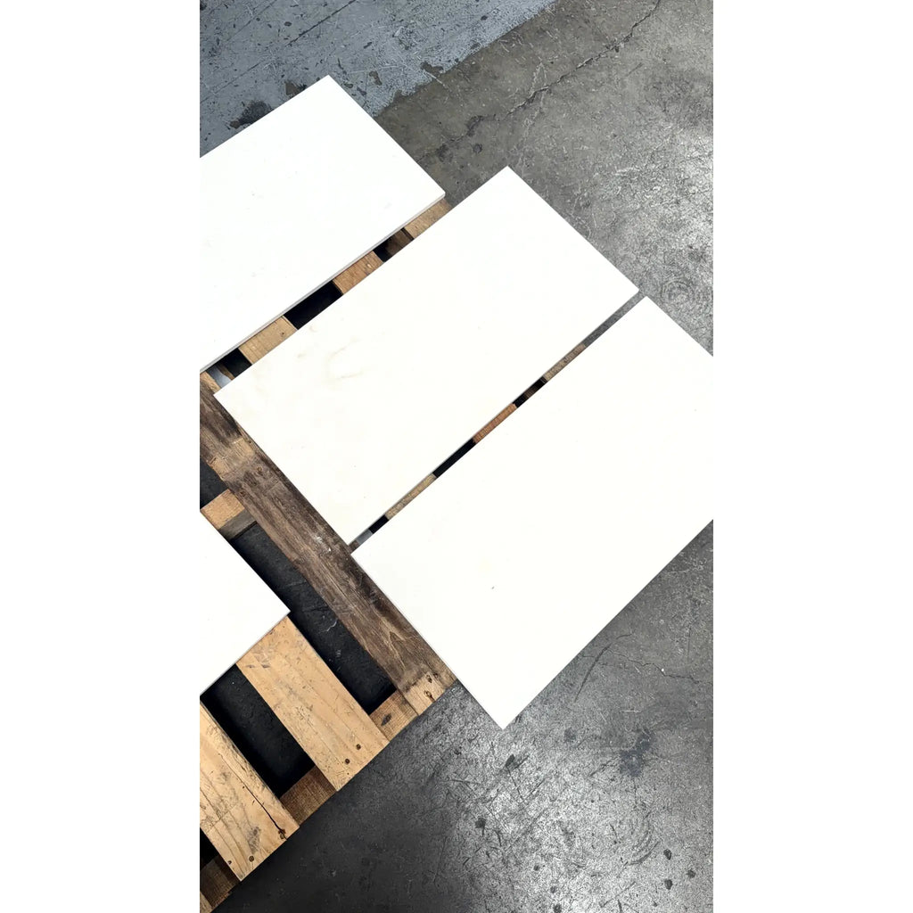 White rectangular champagne limestone honed tiles 12x24 resting on a wooden pallet for flooring or wall use