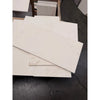 White rectangular champagne lymra 12x24 limestone honed tiles with subtle texture stacked on concrete floor