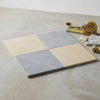 Square marble tiles in two-tone creamy beige and soft gray with natural veining from the checkerboard Bardiglio and Crema Marfil 18x18 set