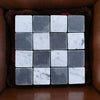Polished black and white marble tiles arranged in a 4x4 checkerboard pattern