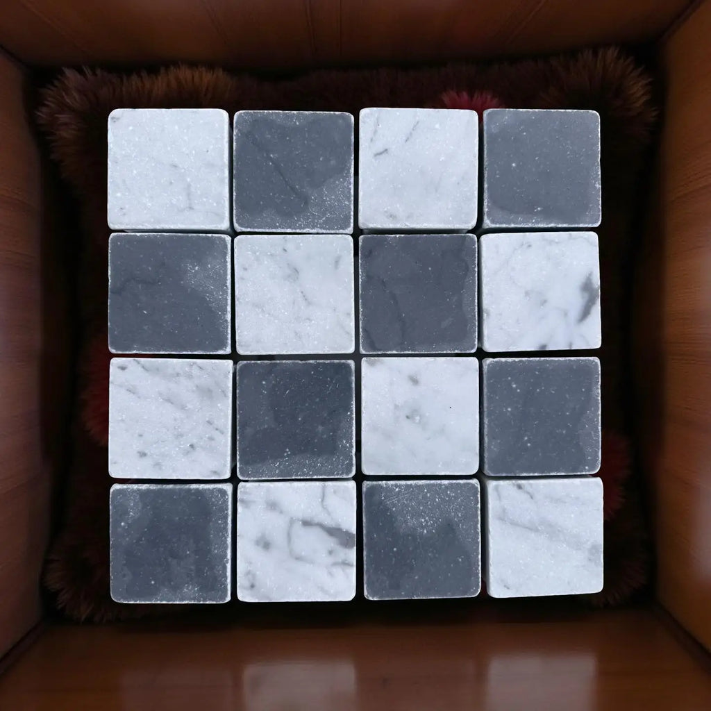 Polished black and white marble tiles arranged in a 4x4 checkerboard pattern