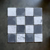 Checkerboard Bardiglio and Carrara White marble tiles in a 3x3 tumbled grid