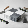 Stack of two-tone gray and white checkered marble coasters from checkerboard bardiglio imperiale and bianco dolomite set