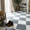 Brown leather chelsea boots on a white and gray marble checkerboard bardiglio imperiale and thassos 18x18 floor
