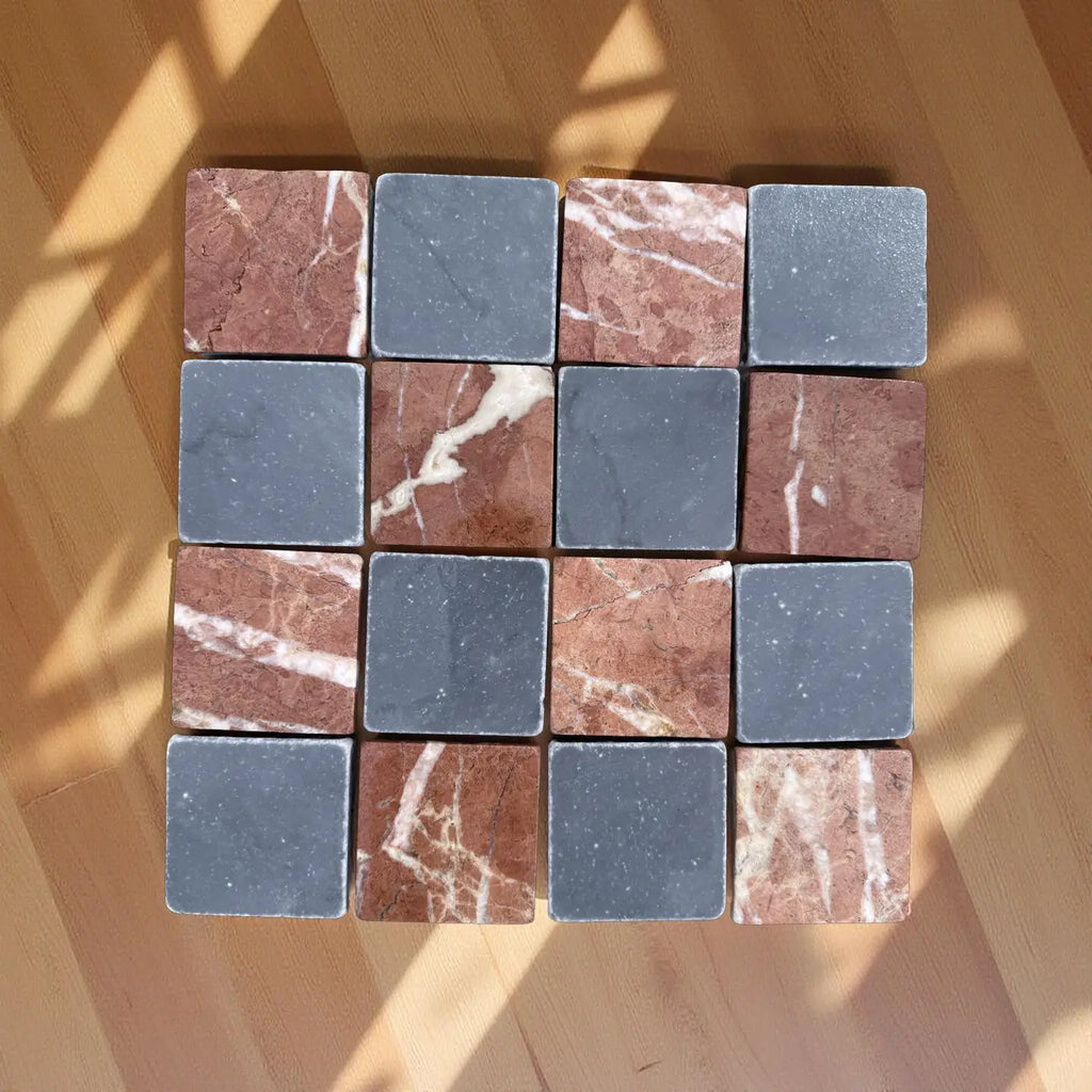 Checkerboard pattern of reddish-brown and dark gray marble tiles with white veining