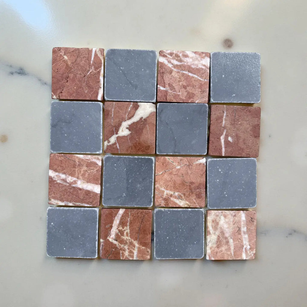 Checkerboard pattern of Red Alicante Bardiglio marble tiles with white veining and gray-blue tiles