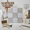 A set of nine 12x12 checkerboard bianco dolomite and crema marfil marble tiles in beige and light gray with natural veining