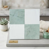A square tile sample board showing checkerboard bianco dolomite white ceramic and ming green marble 12x12 tiles