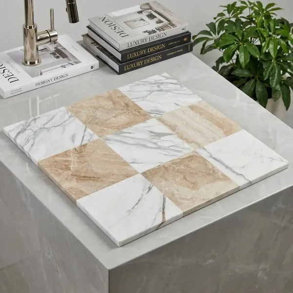A square mosaic tile panel with alternating white calacatta gold marble and beige diano royal marble tiles with natural veining