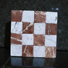Polished white and reddish-brown marble tiles in a checkerboard pattern for elegant flooring