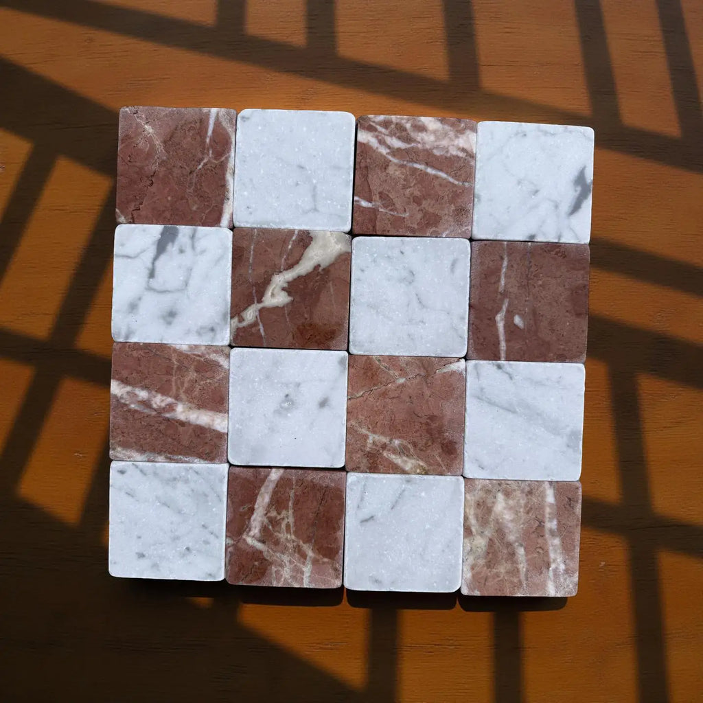 Checkerboard pattern of brown and white marble tiles from Carrara White and Rojo Alicante