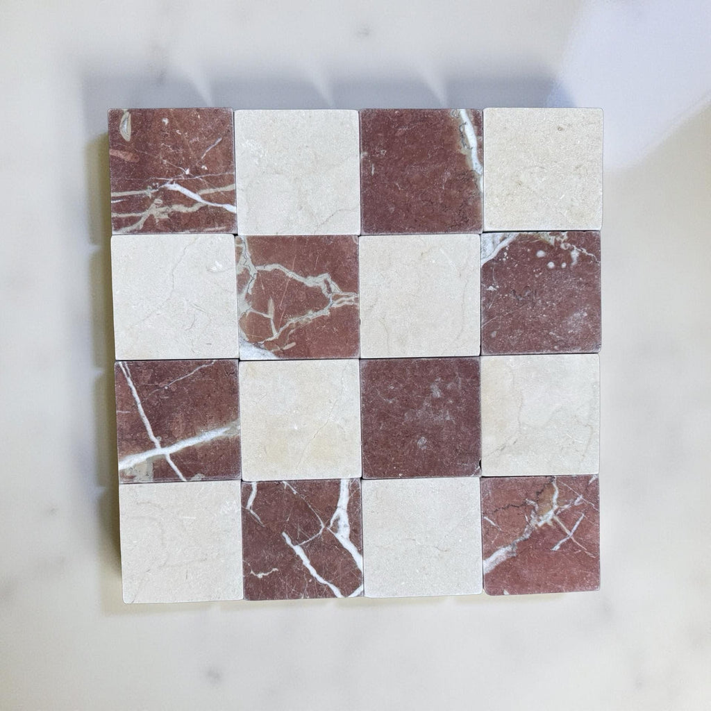 Checkerboard pattern of Red Alicante and Crema Marfil marble tiles in 4x4 tumbled finish