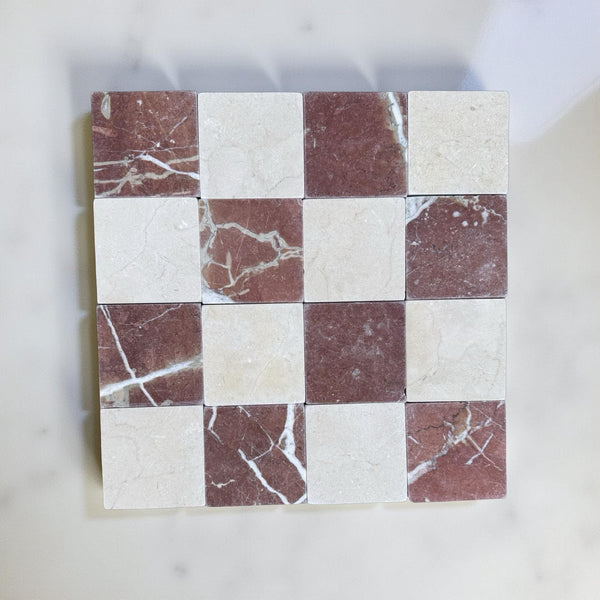 Checkerboard pattern of Red Alicante and Crema Marfil marble tiles in 4x4 tumbled finish