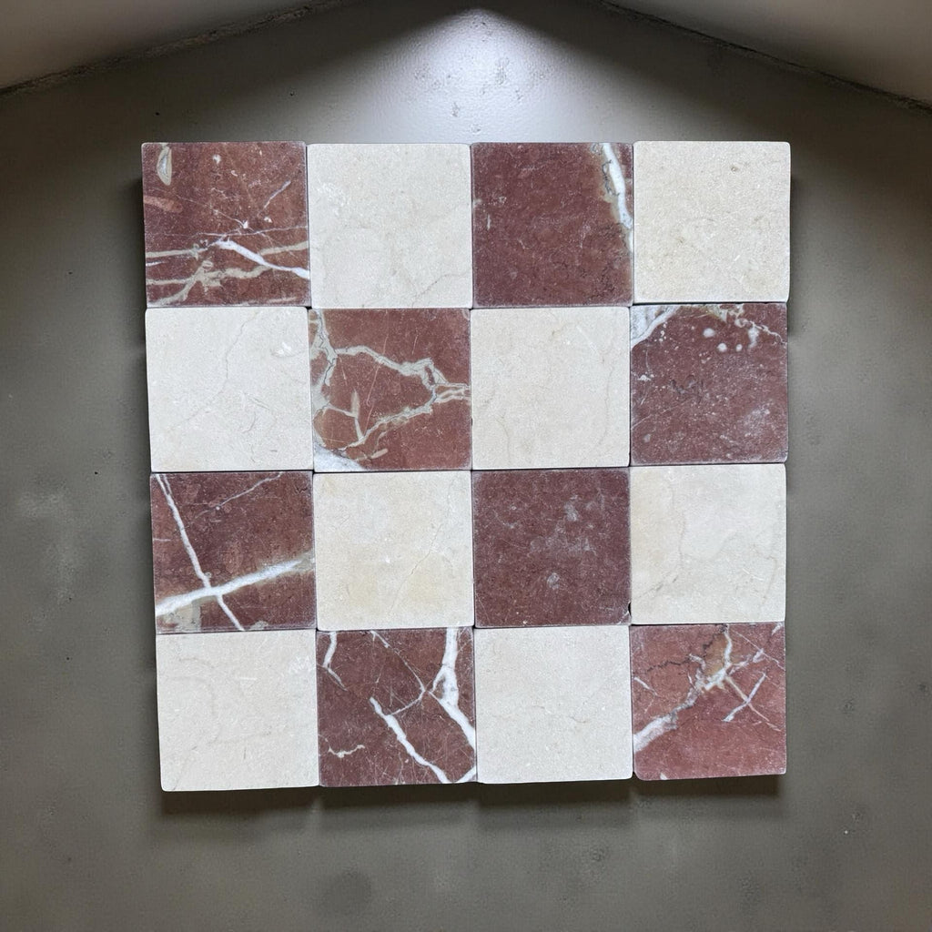Checkerboard pattern of red and white marbled tiles in Checkerboard Crema Marfil Rojo Alicante 4X4 Tumbled