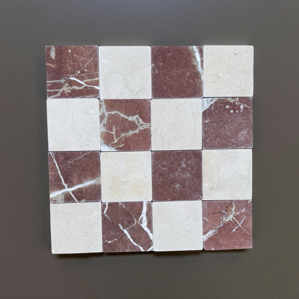 Checkerboard pattern of Red Alicante and Crema Marfil marble tiles in 4x4 tumbled finish