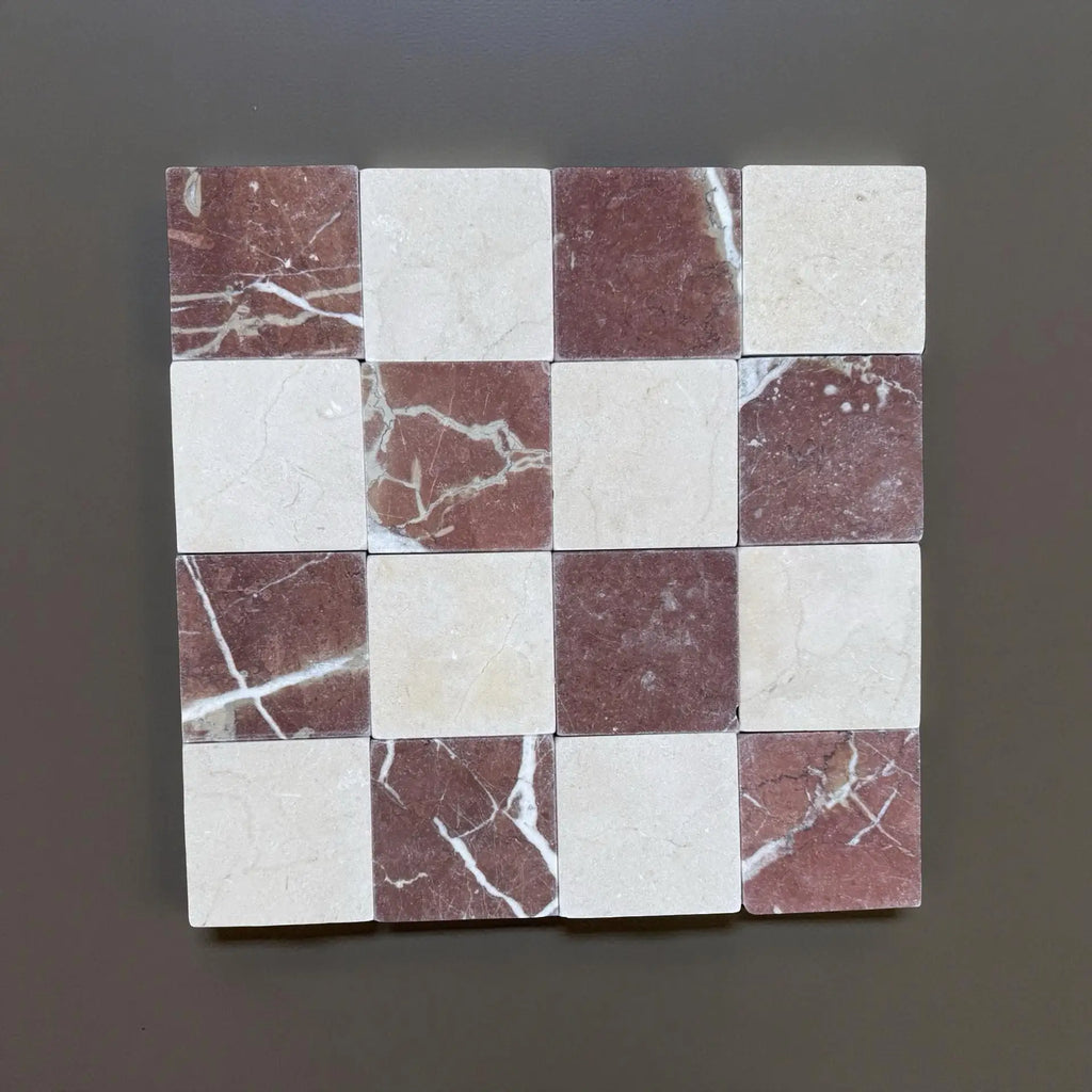 Checkerboard pattern of Red Alicante and Crema Marfil marble tiles in 4x4 tumbled finish