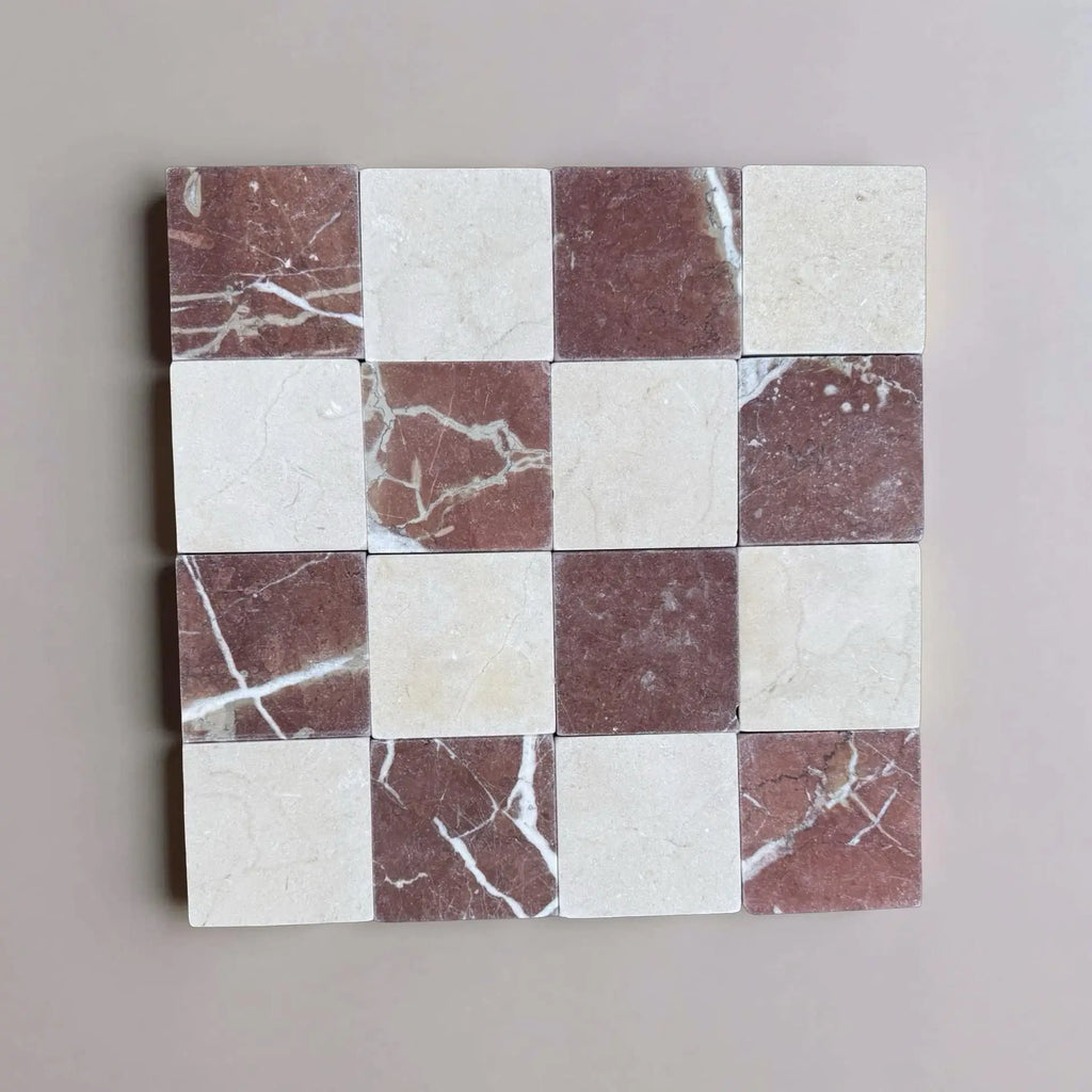 Checkerboard pattern of Crema Marfil and Rojo Alicante marble tiles in 4x4 tumbled finish