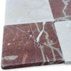 Red and beige marble tiles with prominent veining in Checkerboard Crema Marfil Rojo Alicante pattern