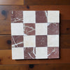 Checkerboard pattern of polished Crema Marfil and Rojo Alicante marble tiles