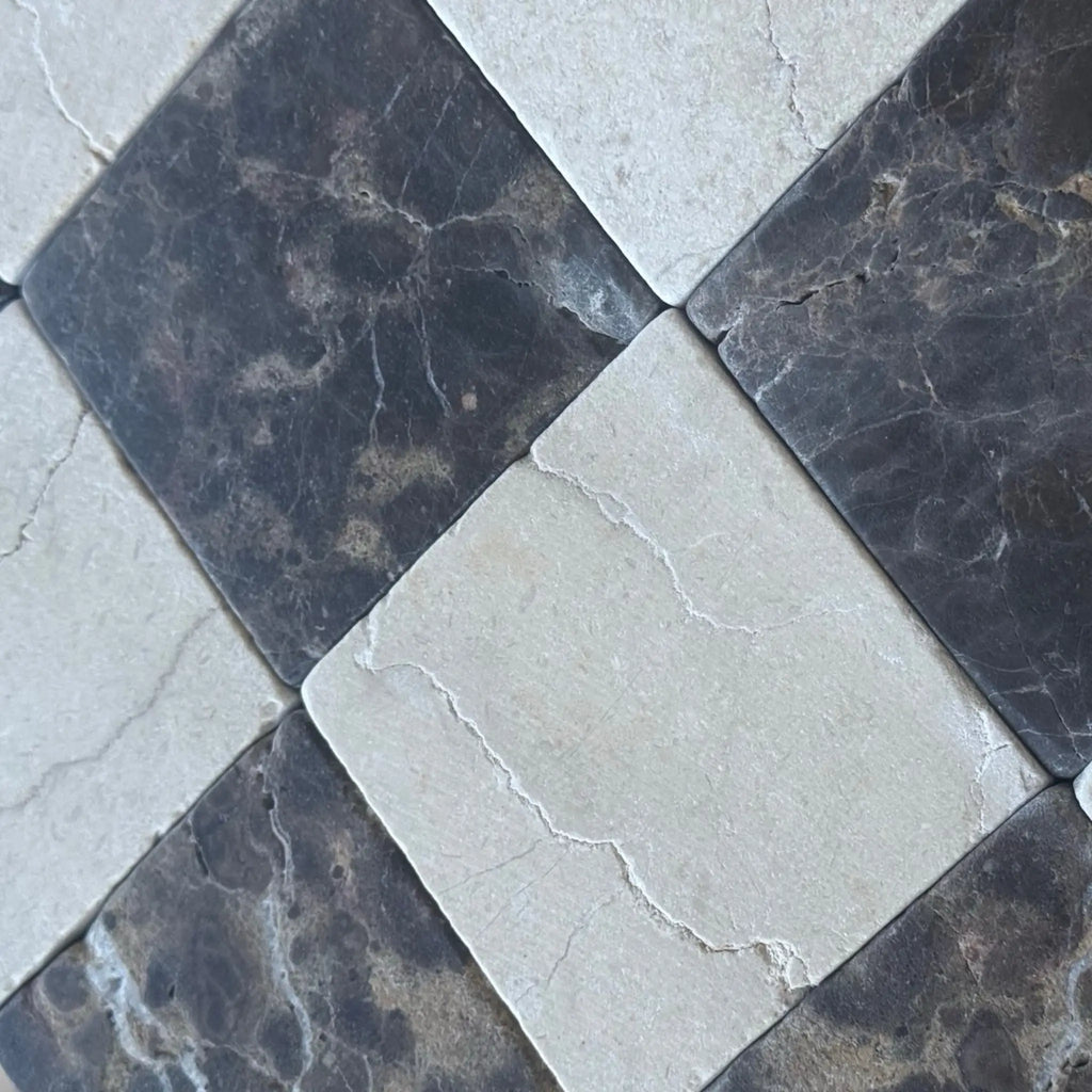 Checkerboard Emperador Dark and Crema Marfil marble tiles in a 6x6 tumbled set