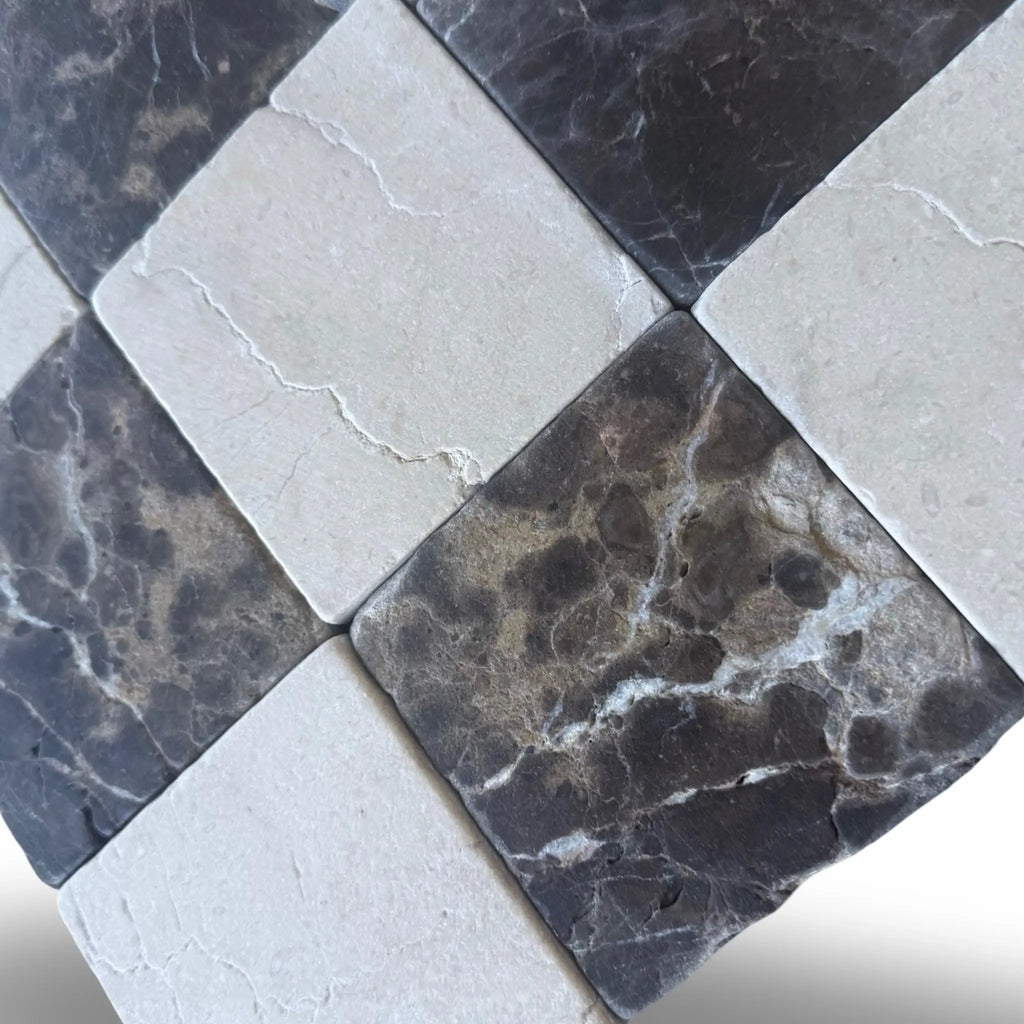 Checkerboard Emperador Dark marble and Crema Marfil tiles with alternating dark and light pattern
