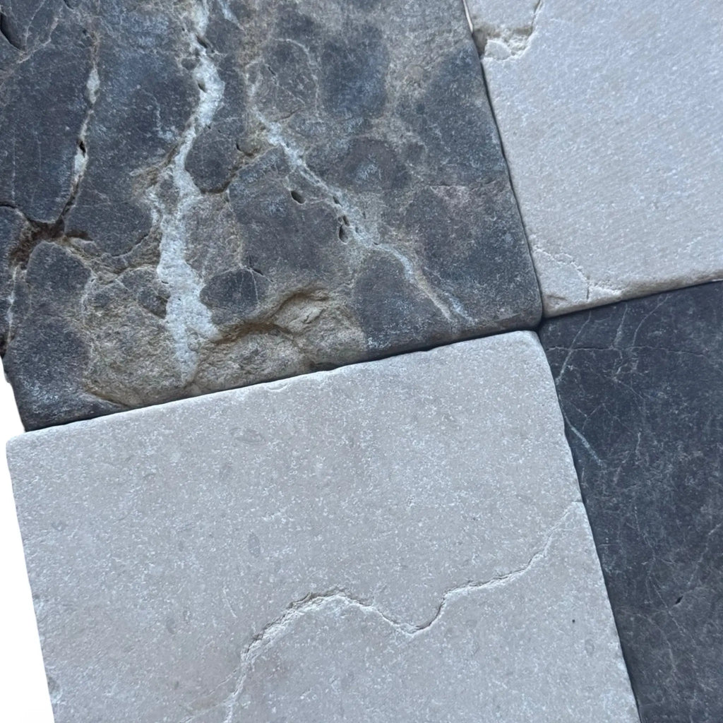 Set of four square stone tiles in Emperador Dark and Crema Marfil Tumbled finish