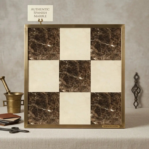 Square decorative panel with checkerboard pattern of dark emperador and crema marfil marble tiles in gold frame