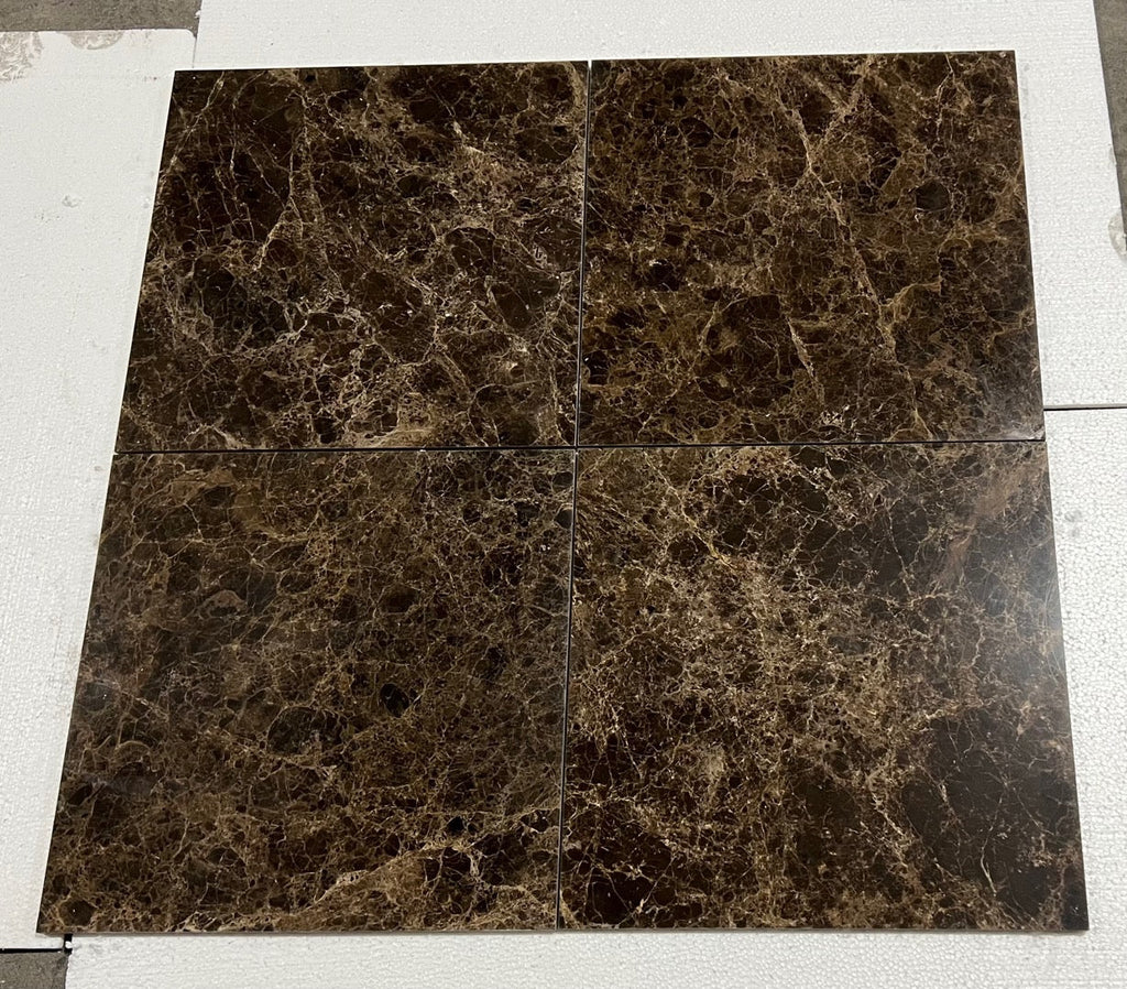Four square brown Emperador Dark marble tiles with golden veining