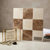 A square marble tile panel with a checkered pattern of creamy white crema marfil and rich brown emperador light stones