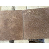 Two brown marble tiles from Checkerboard Ivory and Noce Travertine Tumbled set