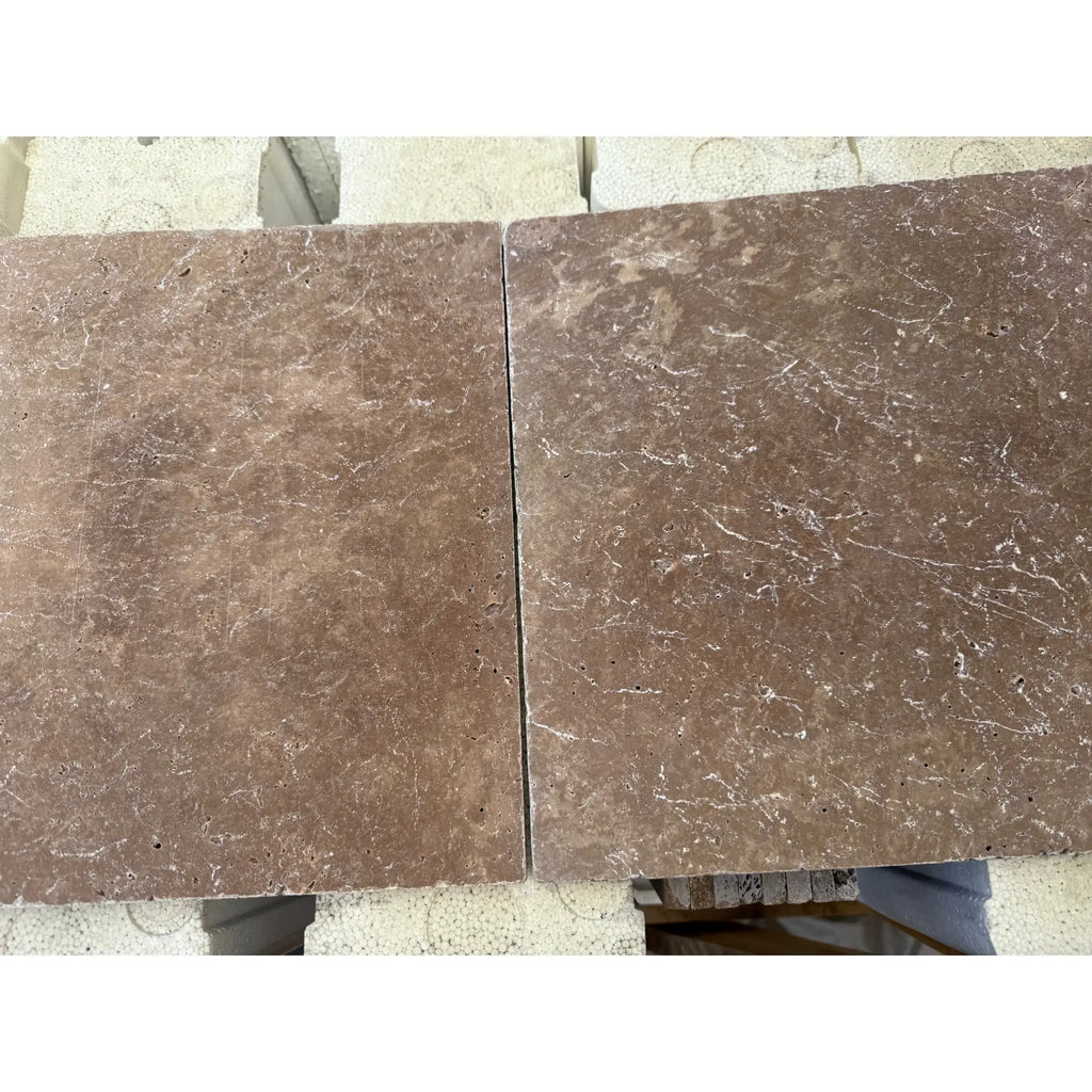 Two brown marble tiles from Checkerboard Ivory and Noce Travertine Tumbled set