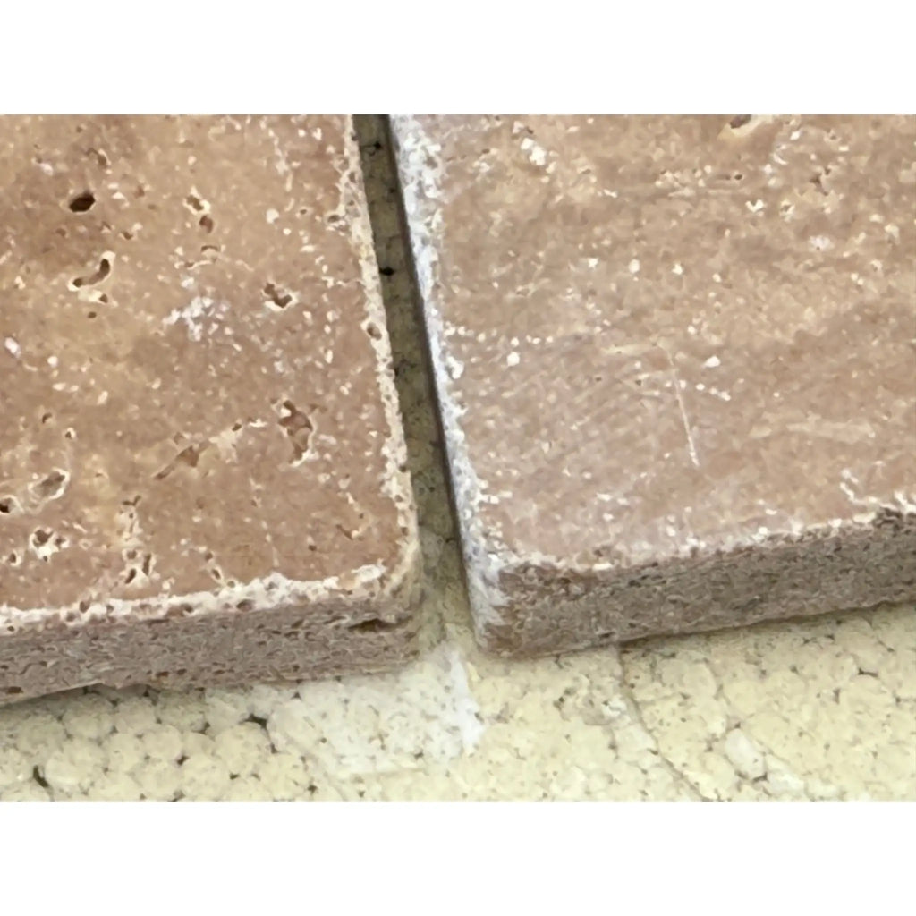 Two beige porous stone tiles from Checkerboard Ivory and Noce Travertine set
