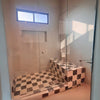 Checkered tiled shower featuring Checkerboard Nero Marquina and Arabescato Corchia Marble