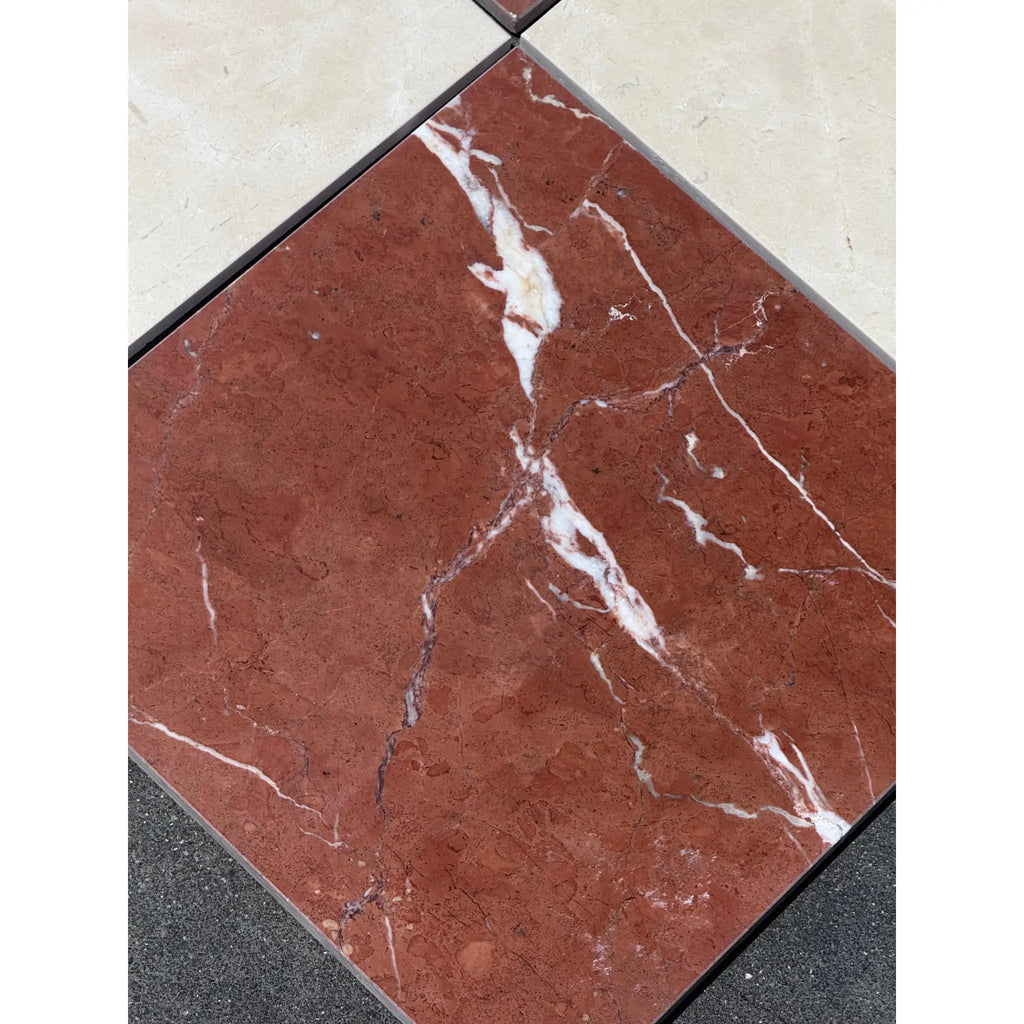 Red marble tile with white veining from Checkerboard Rojo Alicante and Crema Marfil Marble 12X12 Set