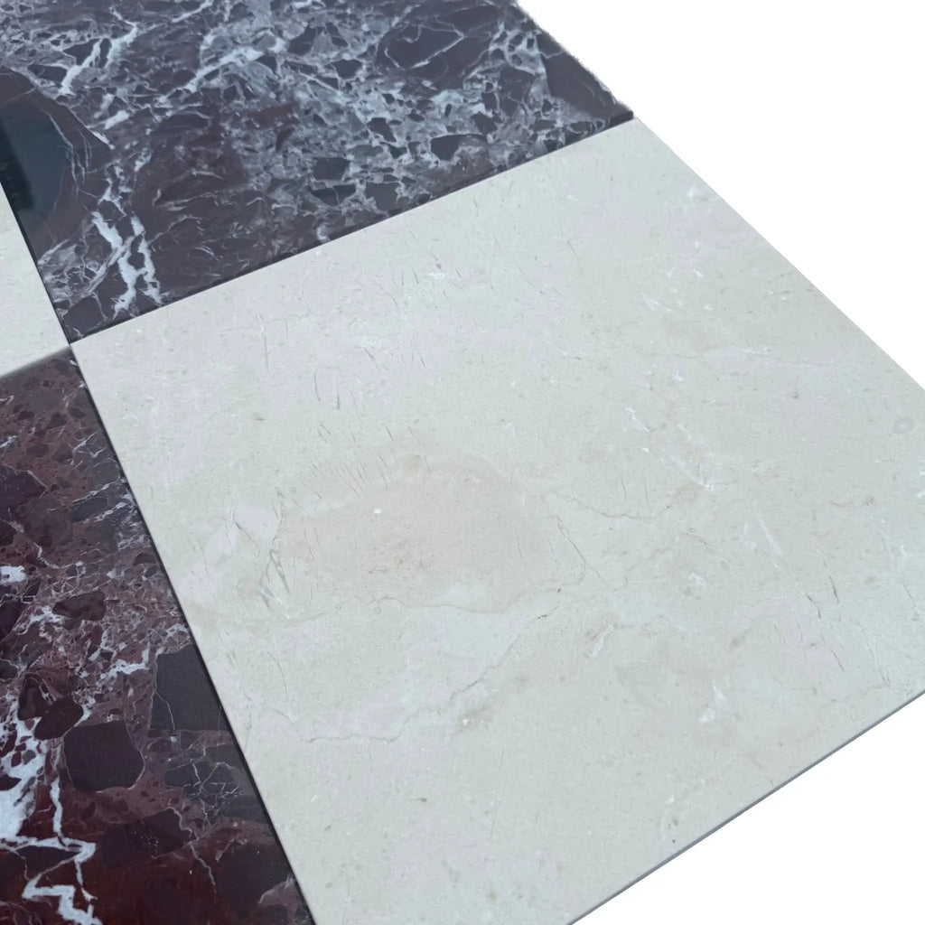 Checkerboard pattern of Rosso Levanto and Crema Marfil marble tiles in a 12x12 set