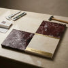 The surfaces galore marble sample book displays polished checkerboard rosso levanto and crema marfil stone slabs