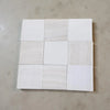 Nine square polished tiles in shades of white and beige with subtle veining, Checkerboard White Onyx Bianco Dolomite