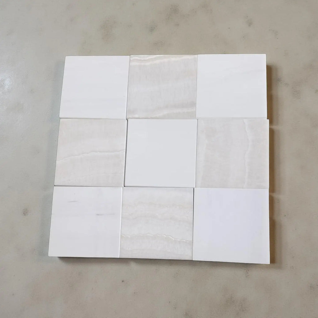 Nine square polished tiles in shades of white and beige with subtle veining, Checkerboard White Onyx Bianco Dolomite