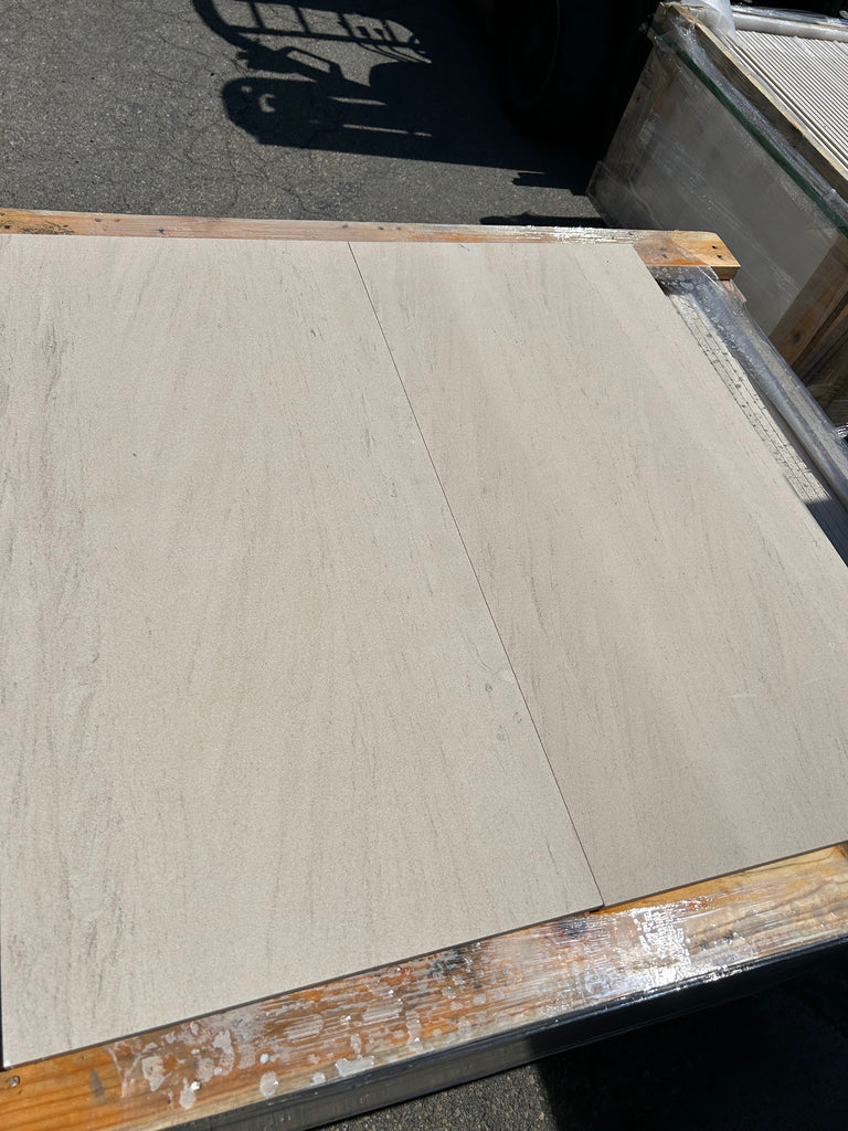 Two Crema Haven 12x24 limestone tiles on wooden pallet