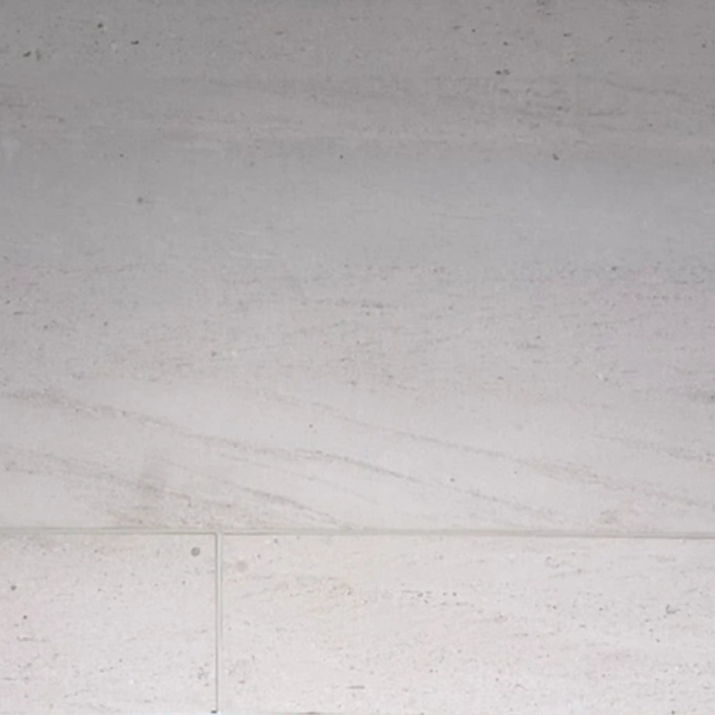 Crema Haven 18x36 limestone brushed tile in light gray with subtle veining and matte finish