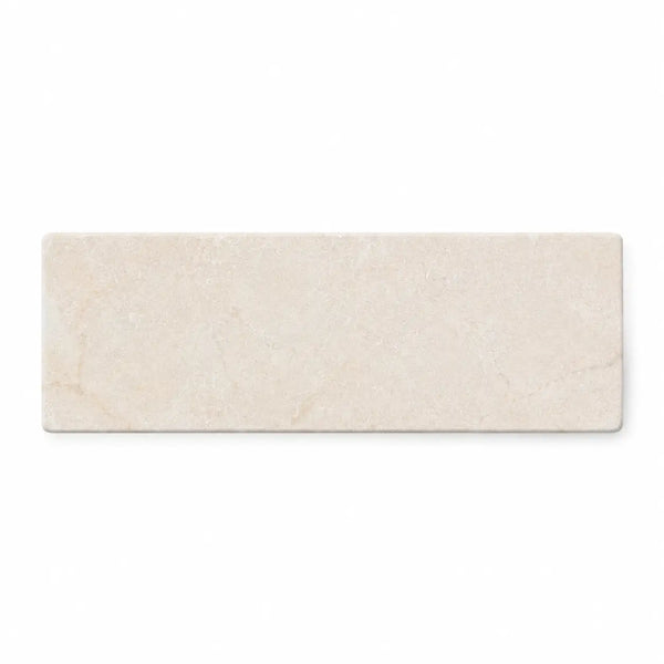 Beige rectangular crema marfil marble tile with subtle natural veining in a 2x6 soft tumbled finish