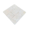 A grid of twelve light-colored Crema Marfil 4X4 Tumbled natural stone tiles with subtle variations